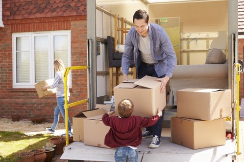 Removal team beginning a Dundee house move with packed boxes